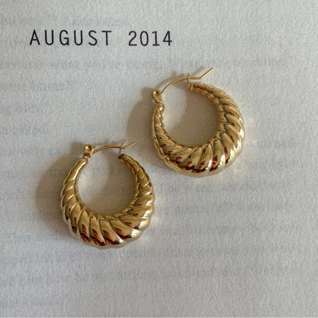 Gold twisted croissant hoop earrings photographed for a marketplace listing